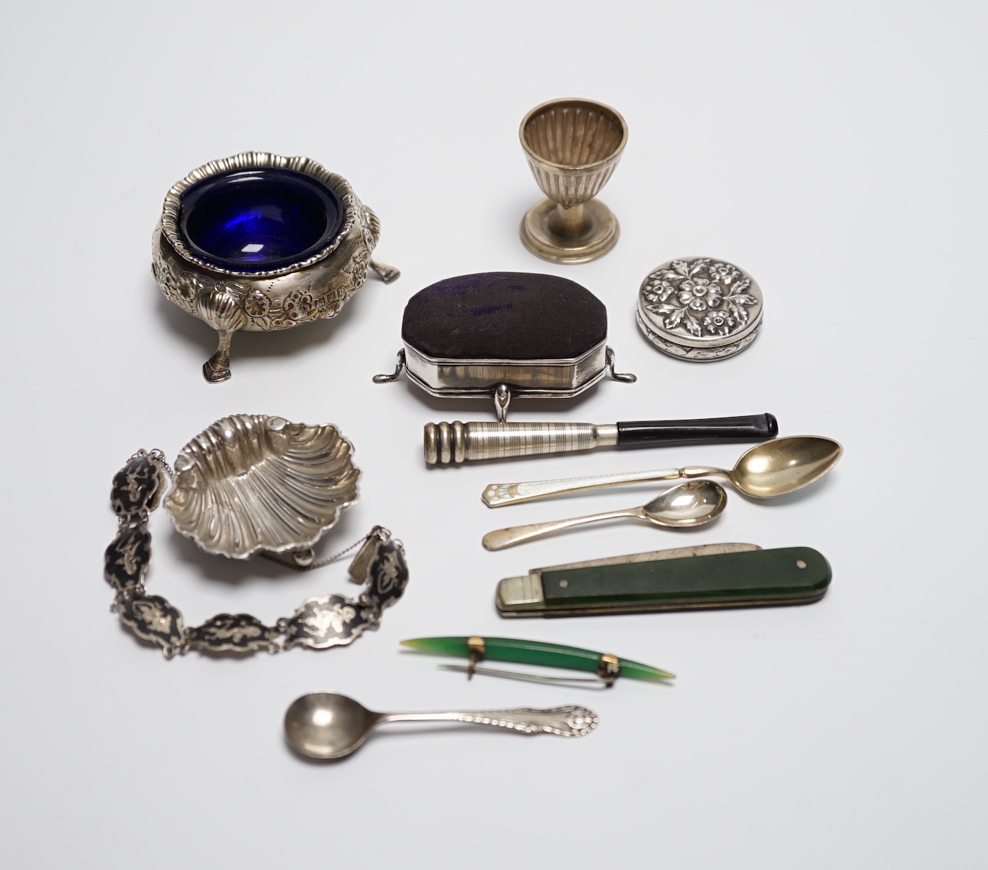 A late Victorian silver bun salt and other items including silver mounted pin cushion, silver shell salt, spoons etc.